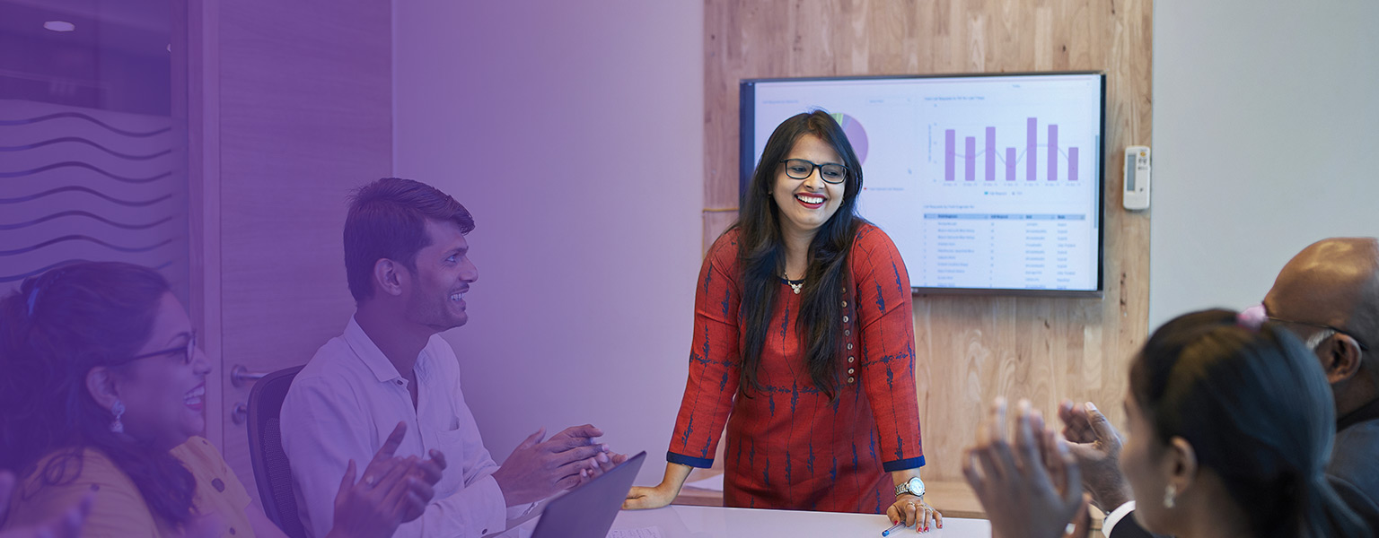 Image of development code on a computer screen superimposed over an indian business woman